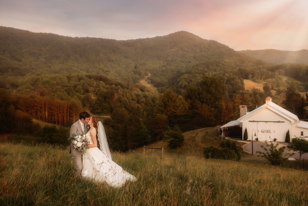 Newlyweds kiss on their Wedding Day at Chestnut Ridge Events in Canton, NC after learning about the Best Mountain Wedding Venues in Asheville, NC.
