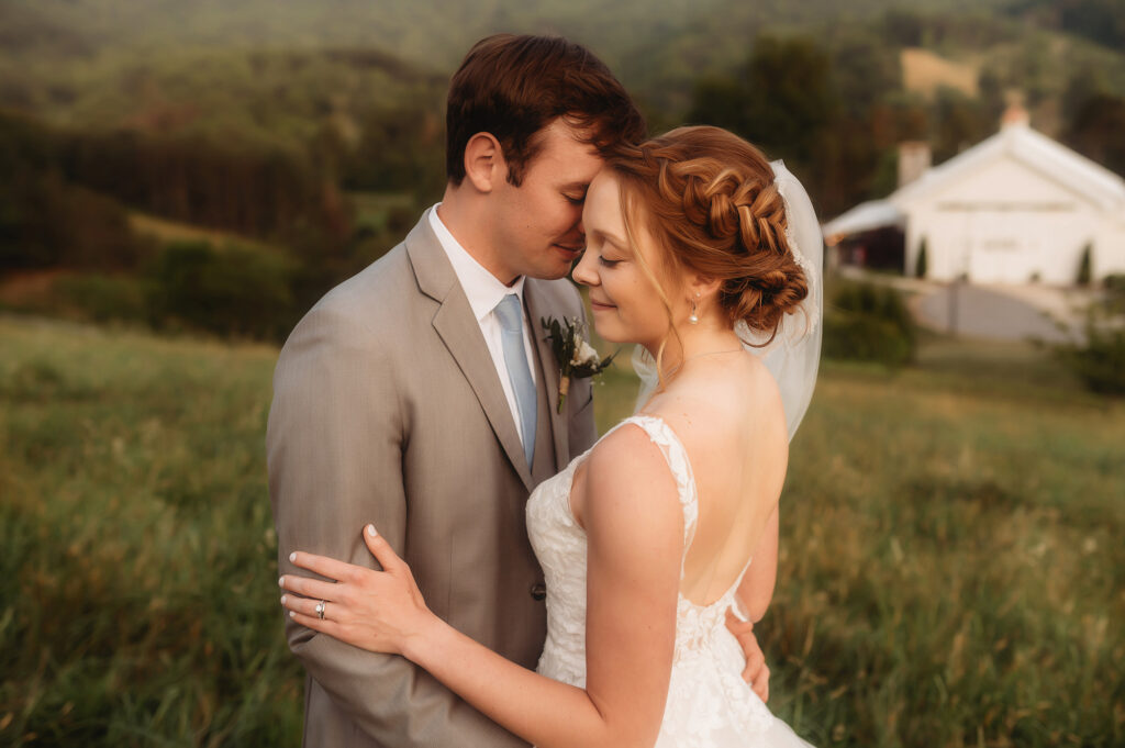 Newlyweds kiss on their Wedding Day at Chestnut Ridge Events in Canton, NC after learning about the Best Mountain Wedding Venues in Asheville, NC.